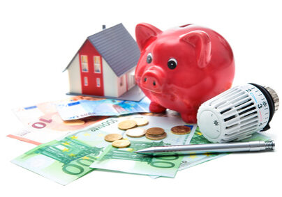 Heating thermostat with piggy bank and money, expensive heating costs concept